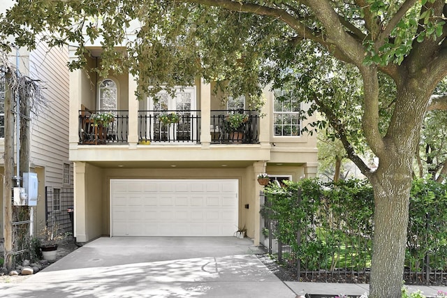 view of front of home featuring a garage and a balcony