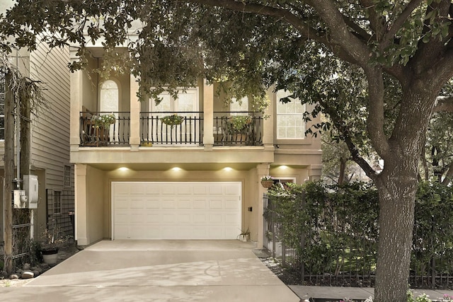 view of front of home featuring a garage and a balcony