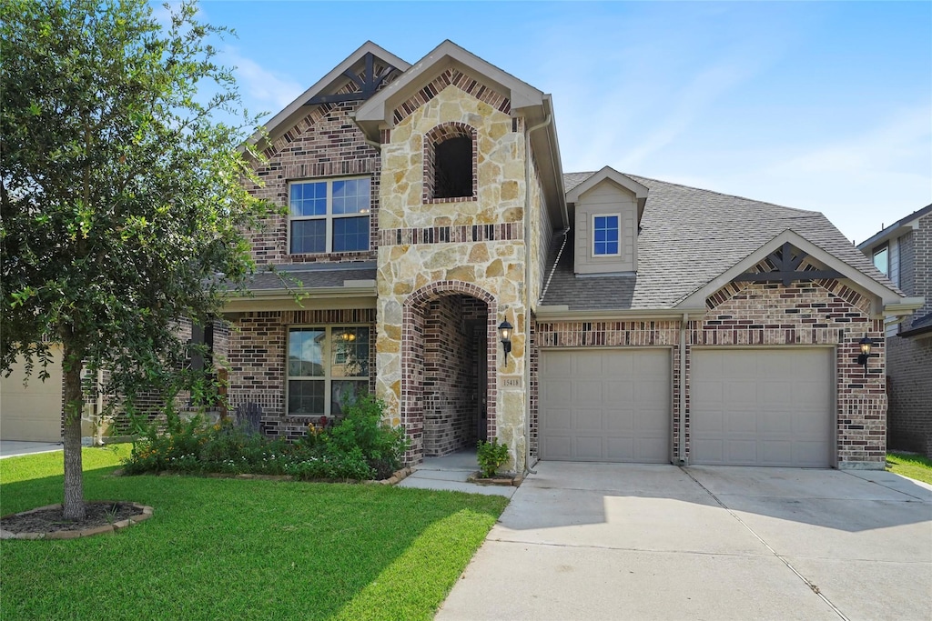 view of front of property with a garage and a front yard