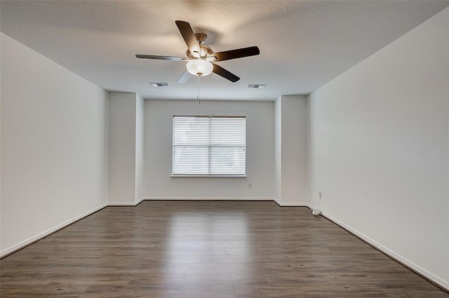 unfurnished room featuring a textured ceiling, dark wood-type flooring, and ceiling fan