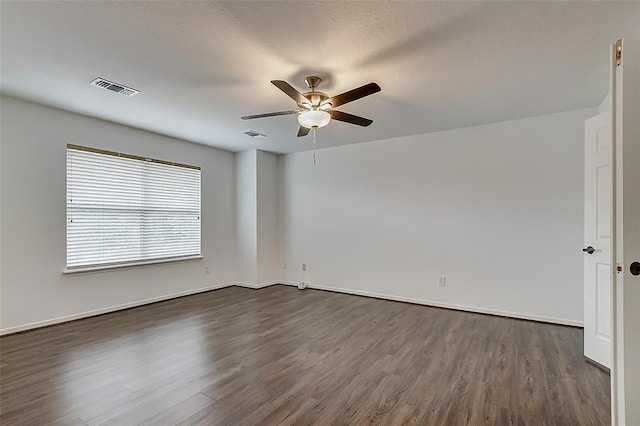 unfurnished room featuring ceiling fan and dark hardwood / wood-style flooring