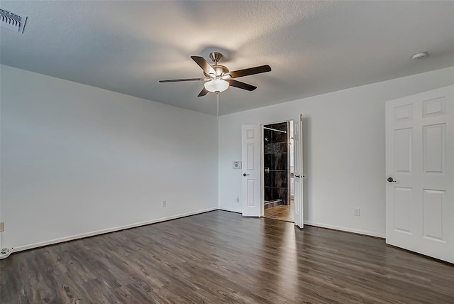 empty room with dark hardwood / wood-style floors and ceiling fan