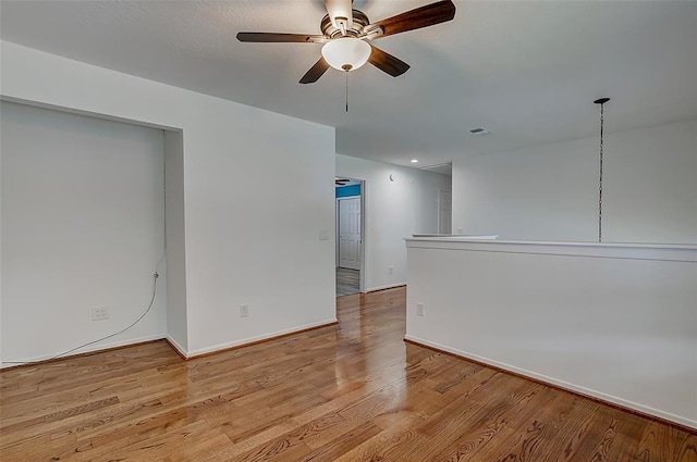 spare room featuring ceiling fan and light hardwood / wood-style flooring