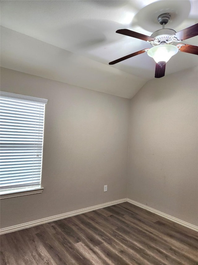 spare room featuring dark hardwood / wood-style flooring, vaulted ceiling, and ceiling fan