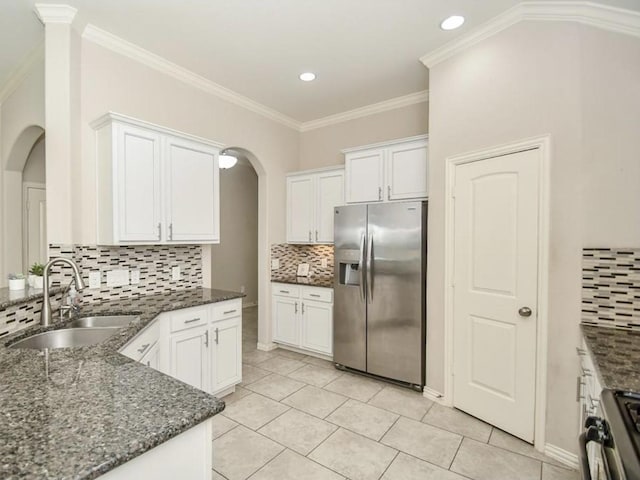 kitchen featuring white cabinetry, sink, dark stone counters, and appliances with stainless steel finishes