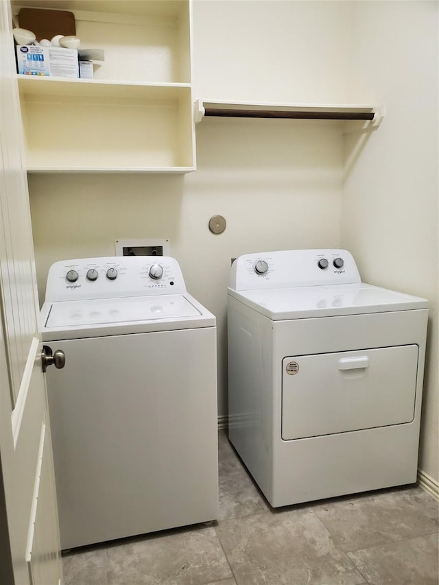 clothes washing area with washing machine and dryer