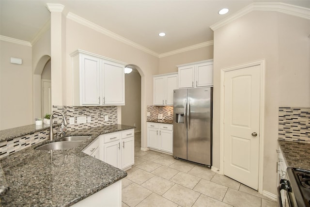 kitchen with range with gas cooktop, white cabinetry, sink, dark stone countertops, and stainless steel fridge with ice dispenser