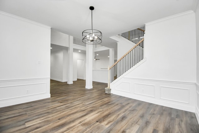 interior space with crown molding, dark wood-type flooring, and a chandelier