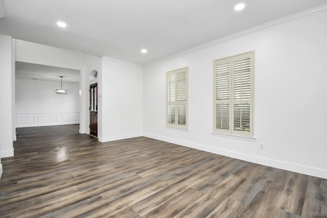 empty room featuring ornamental molding and dark hardwood / wood-style floors