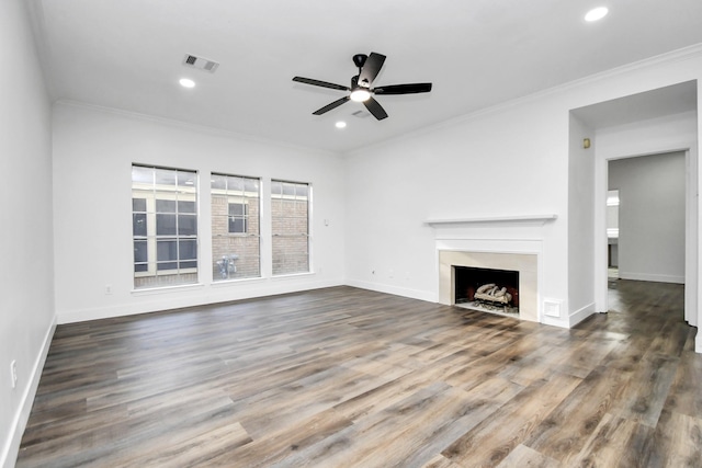 unfurnished living room with ceiling fan, ornamental molding, and hardwood / wood-style floors