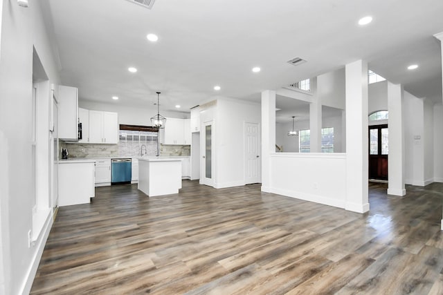 kitchen with dishwasher, white cabinetry, backsplash, a center island, and decorative light fixtures