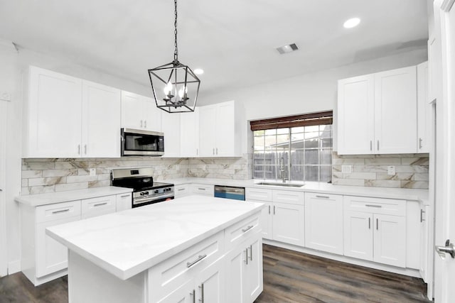 kitchen featuring stainless steel appliances, sink, and white cabinets