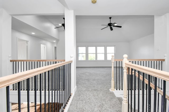 corridor featuring lofted ceiling and carpet floors