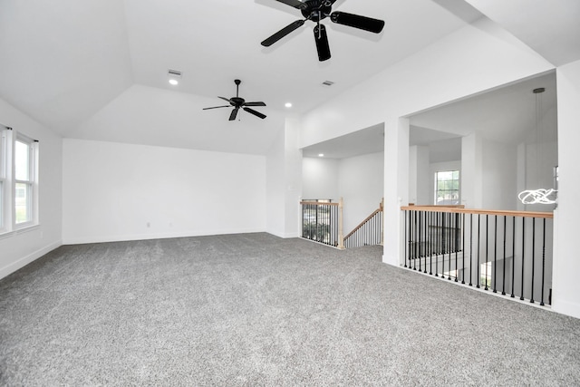 carpeted empty room featuring lofted ceiling and plenty of natural light