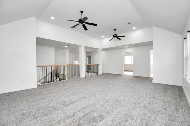 unfurnished living room with vaulted ceiling, carpet flooring, and ceiling fan