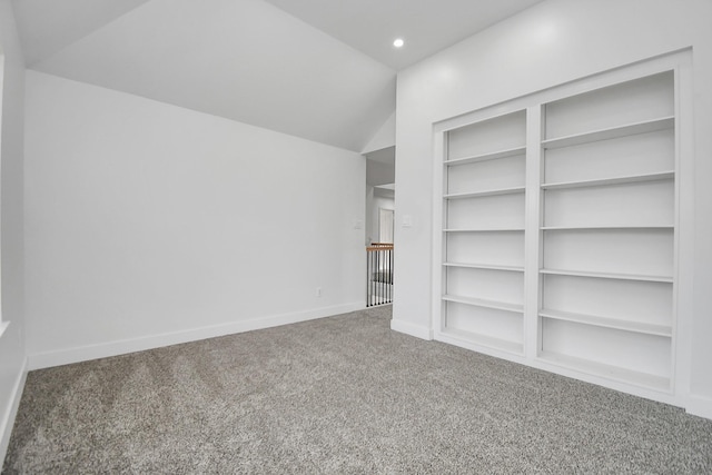 interior space with vaulted ceiling and carpet floors