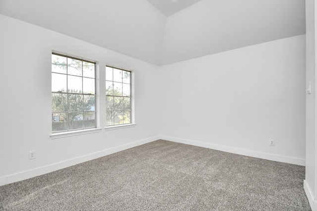 unfurnished room with lofted ceiling and carpet flooring