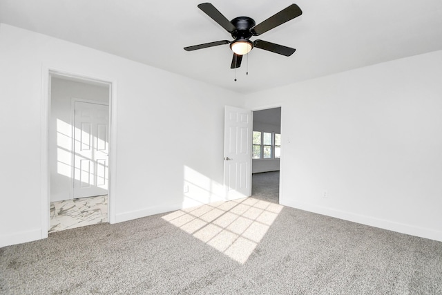 carpeted spare room with ceiling fan