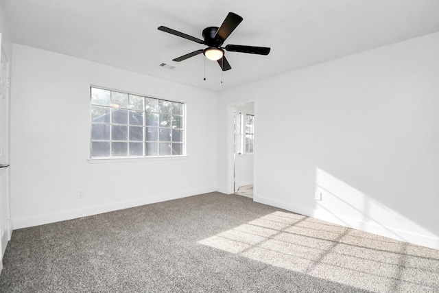 unfurnished room featuring ceiling fan, a healthy amount of sunlight, and carpet flooring