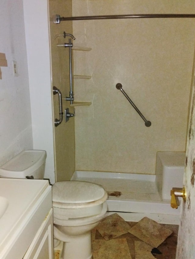 full bathroom with toilet, vanity, a shower, and tile patterned floors