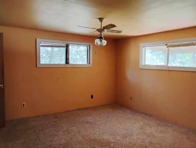 carpeted empty room featuring a ceiling fan