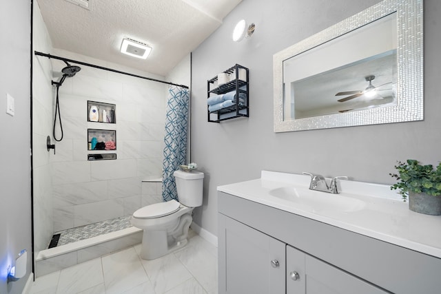 bathroom with ceiling fan, vanity, a textured ceiling, a shower with curtain, and toilet