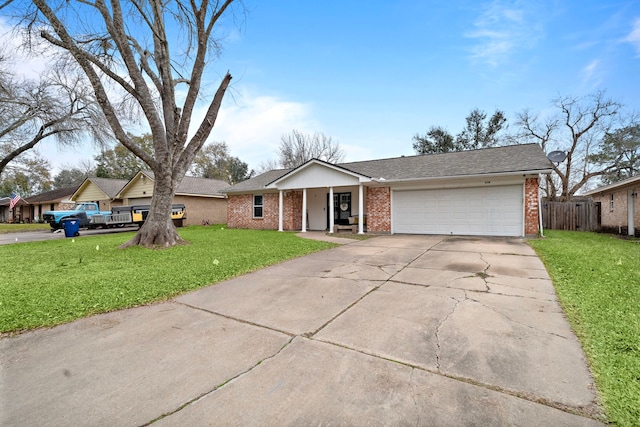 ranch-style home featuring a garage and a front lawn