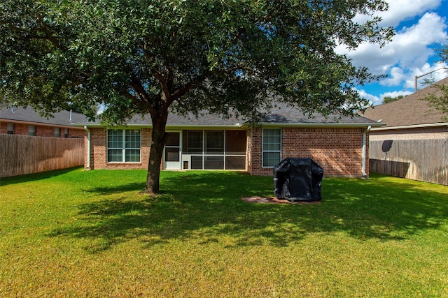 back of house with a lawn