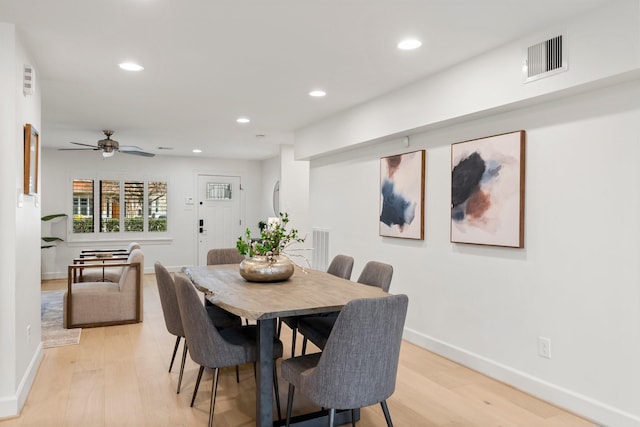 dining area with light hardwood / wood-style flooring and ceiling fan