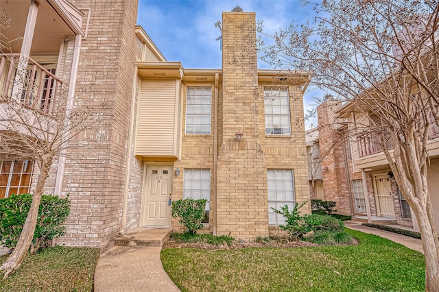 view of property featuring a front lawn