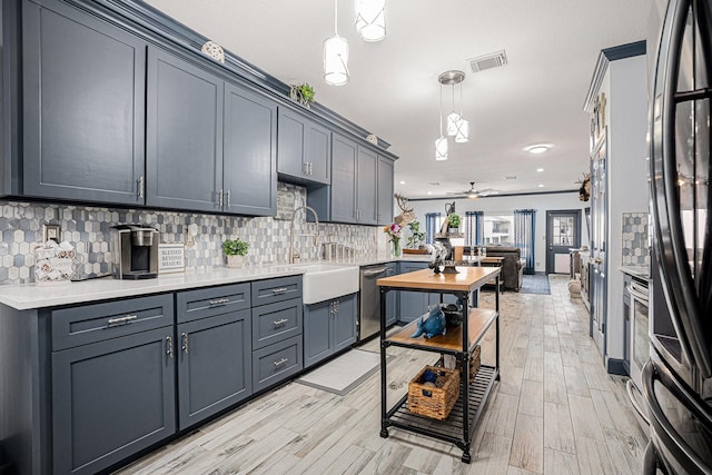 kitchen with gray cabinetry, hanging light fixtures, and backsplash