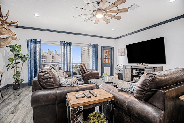 living room with crown molding, ceiling fan, and light hardwood / wood-style floors