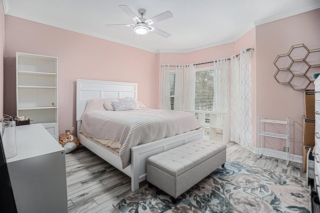 bedroom with crown molding, ceiling fan, and light hardwood / wood-style flooring