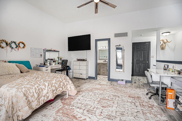 bedroom with light hardwood / wood-style flooring, ceiling fan, and ensuite bathroom