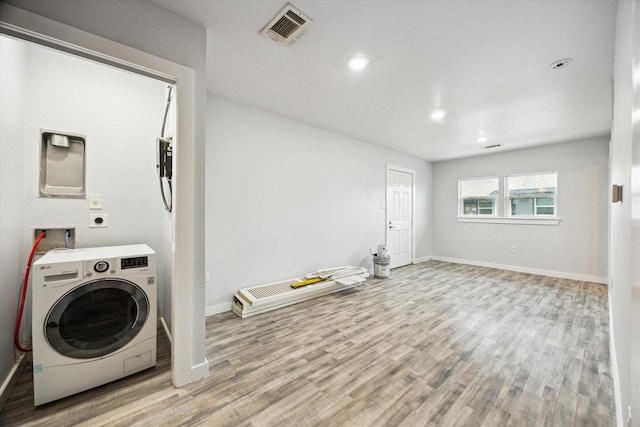 laundry area with washer / clothes dryer and light hardwood / wood-style floors