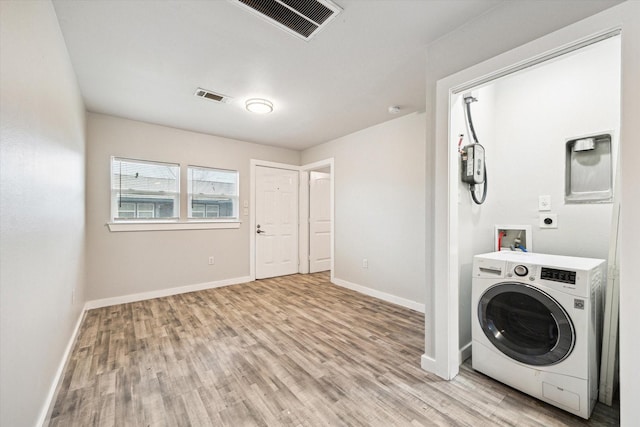 laundry room with washer / clothes dryer and light hardwood / wood-style floors