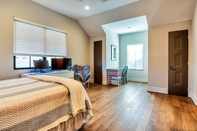 bedroom with light wood-style flooring, baseboards, vaulted ceiling, and recessed lighting