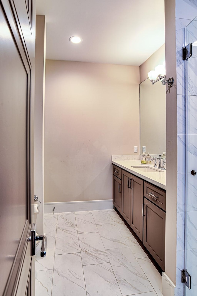 bathroom featuring recessed lighting, vanity, baseboards, marble finish floor, and a shower stall