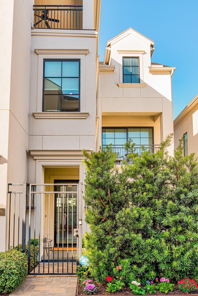 view of front facade featuring a gate and stucco siding