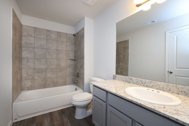 full bath with vanity, wood finished floors, visible vents, shower / bath combination, and toilet