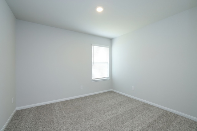 empty room with baseboards and carpet flooring