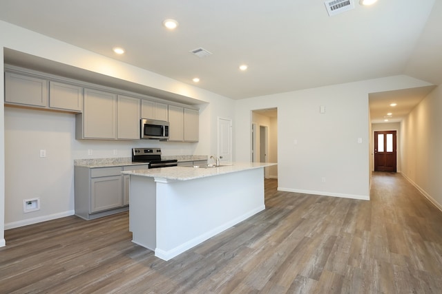kitchen with wood finished floors, visible vents, appliances with stainless steel finishes, and gray cabinetry