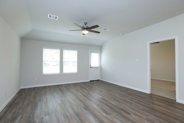 spare room featuring visible vents, baseboards, and dark wood-type flooring