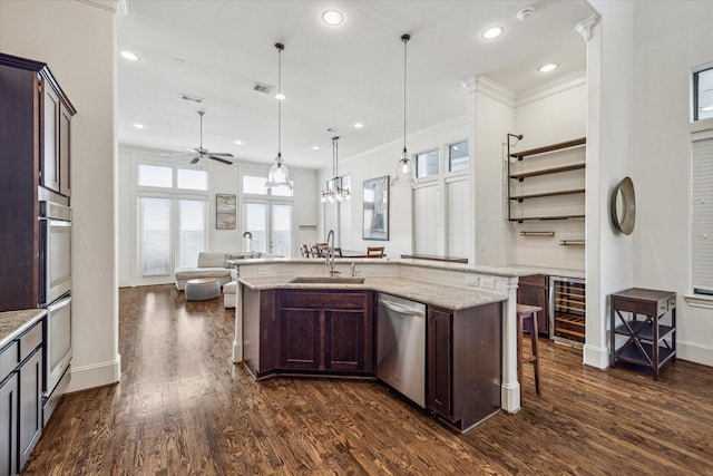 kitchen with pendant lighting, dishwasher, sink, and dark brown cabinets