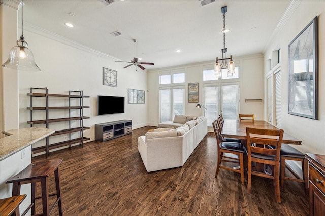 living room with crown molding, ceiling fan with notable chandelier, and dark hardwood / wood-style floors