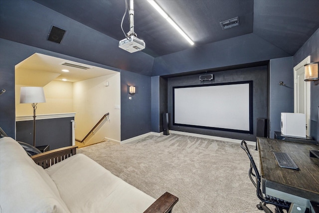 home theater featuring vaulted ceiling and carpet flooring