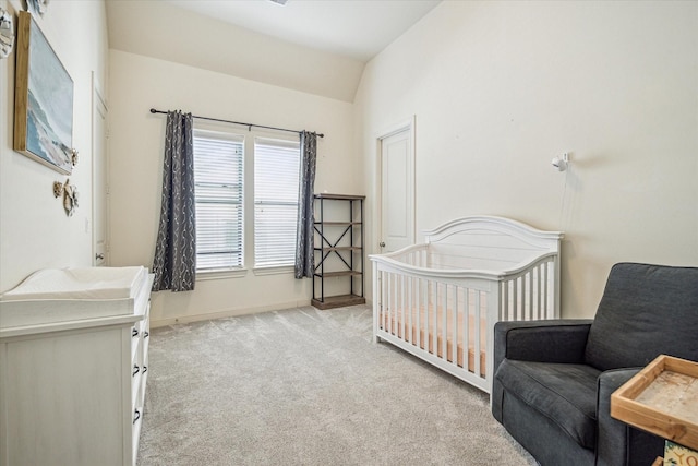 carpeted bedroom featuring a crib