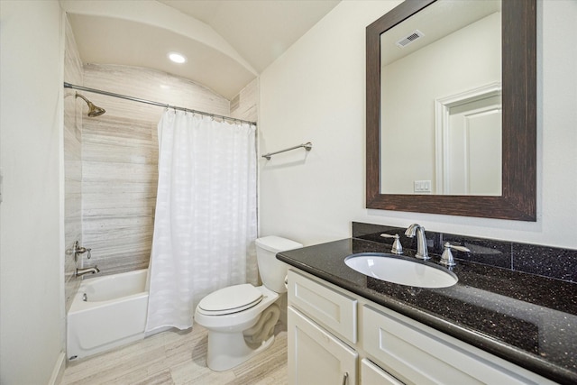 full bathroom featuring vanity, wood-type flooring, shower / tub combo, and toilet