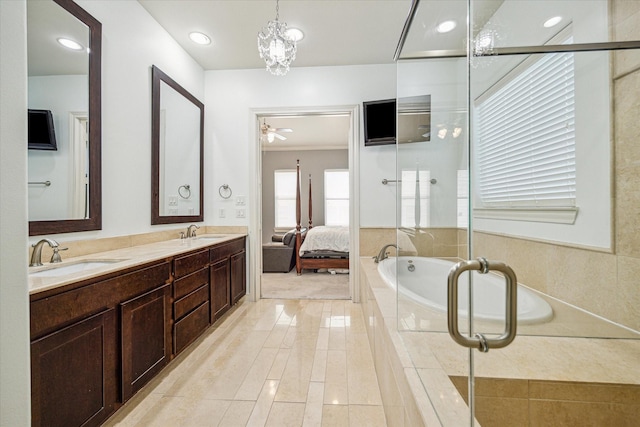 bathroom with vanity, tiled bath, and ceiling fan