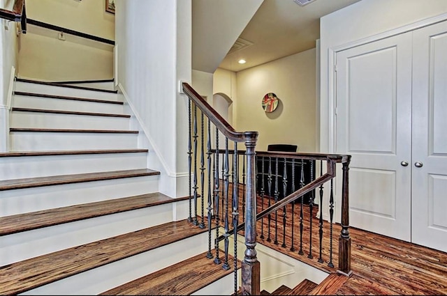 stairway with hardwood / wood-style floors